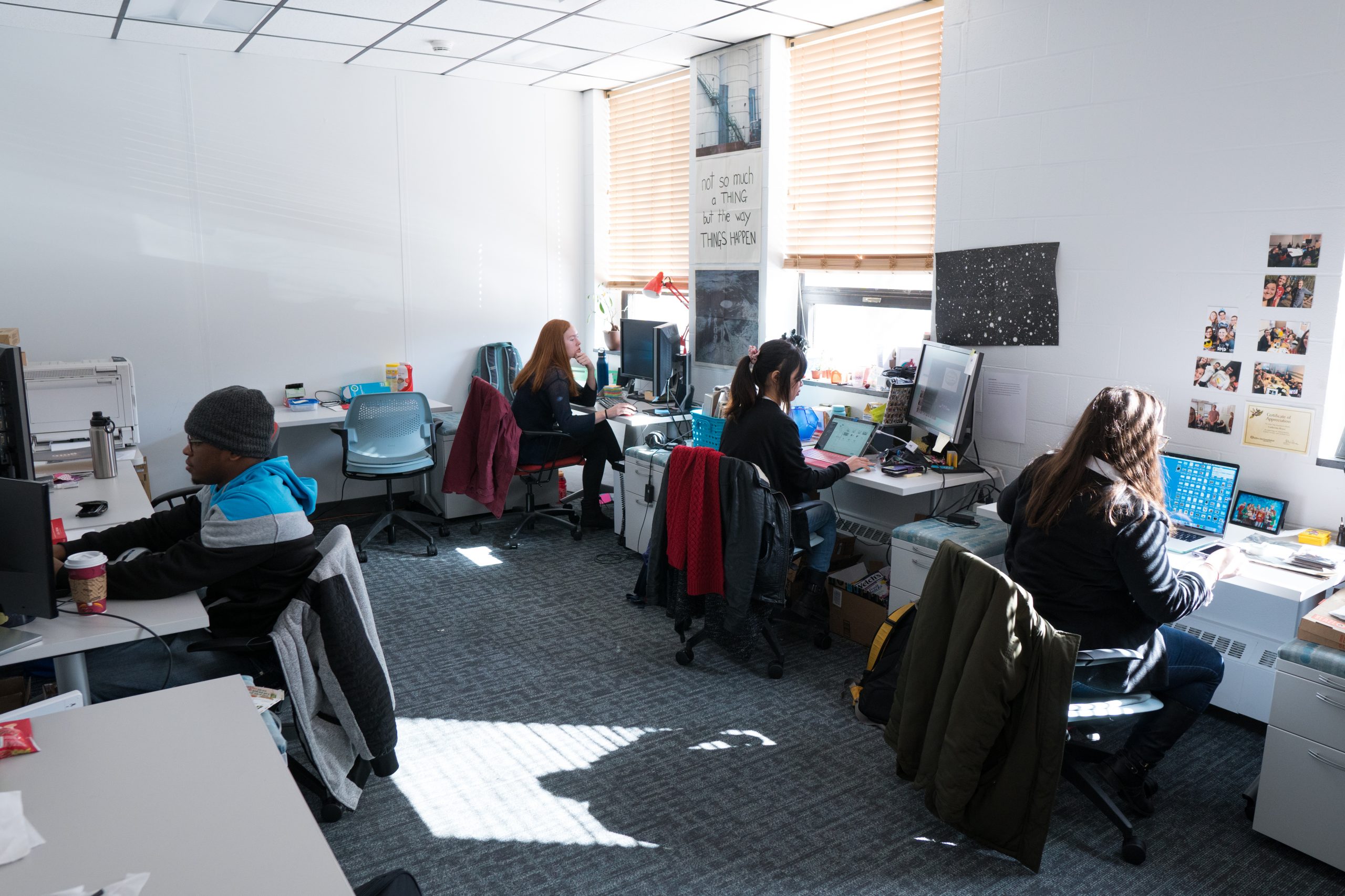 Photo of graduate students working in the graduate studio