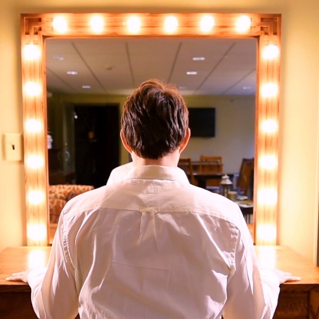 actor staring into dressing room